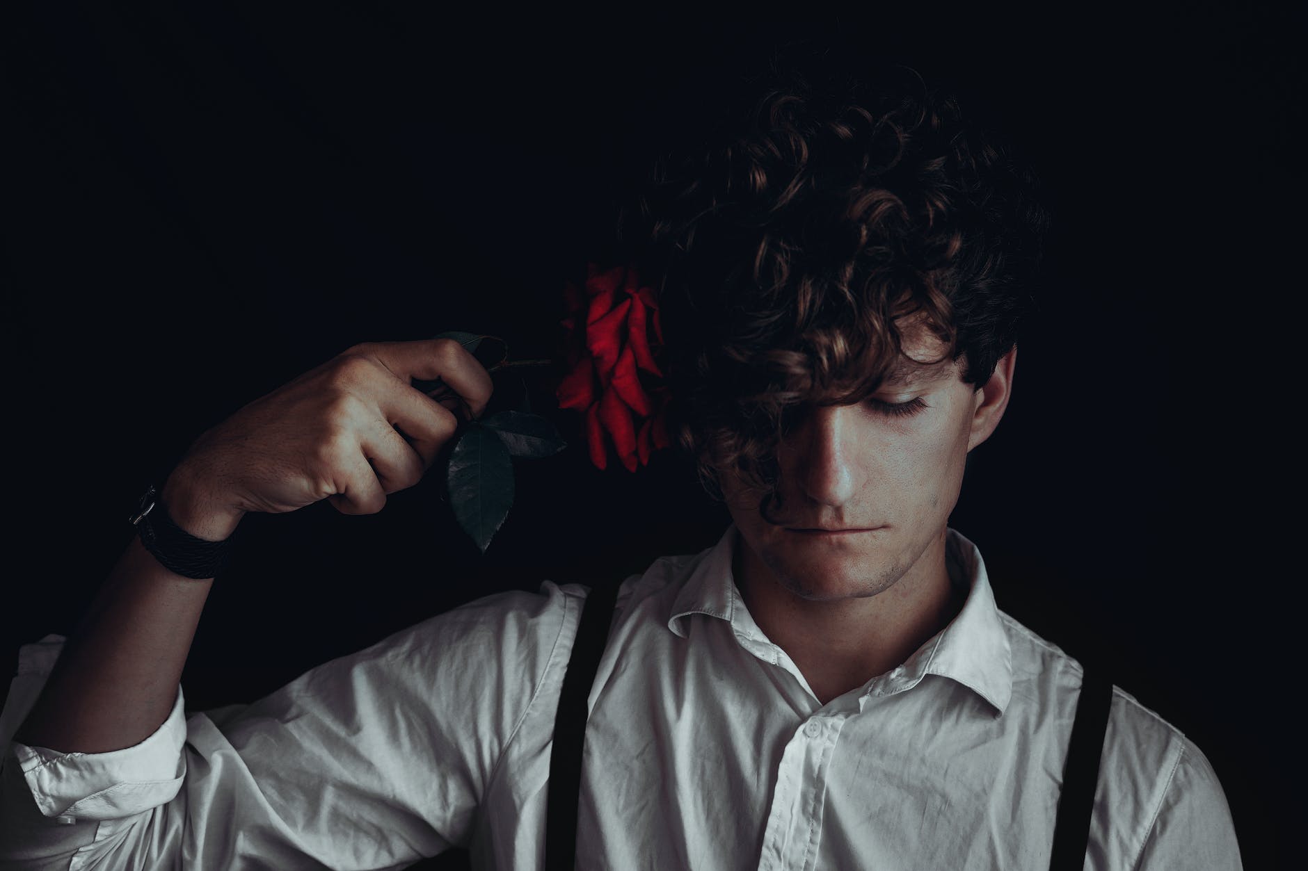 youngster putting rose flower to head in suicidal thoughts